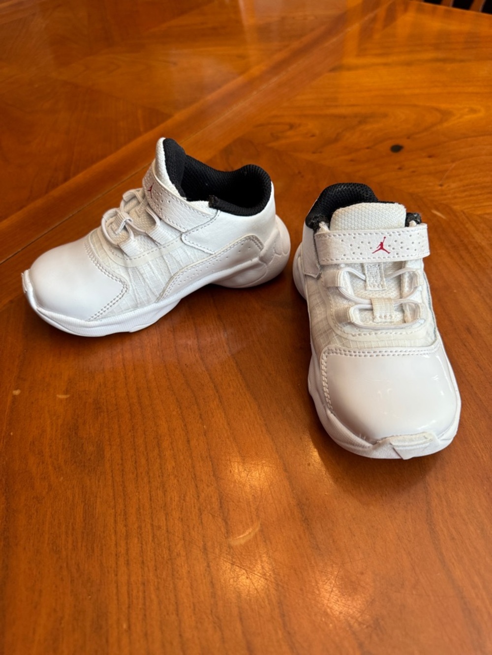 Jordan Kids White Sneakers with Black Lining and Red Logo